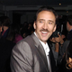 Nicolas Cage laughs at a cocktail party